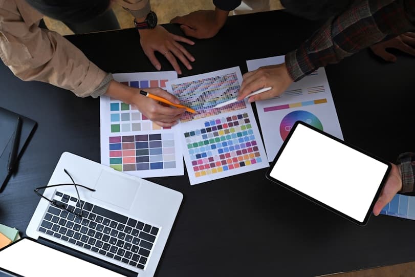 Team reviewing color palettes and designs for The Planning Bord